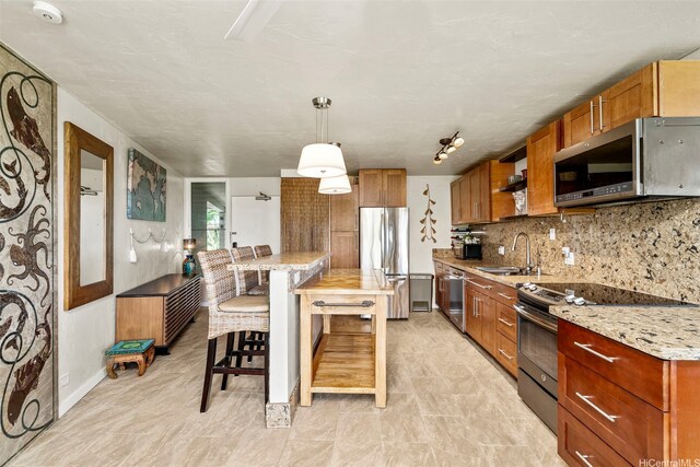 87-561 Farrington Hwy Unit 102, Waianae, HI 96792 - kitchen featuring stainless steel appliances, a sink, brown cabinetry, and backsplash