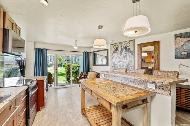 87-561 Farrington Hwy Unit 102, Waianae, HI 96792 - kitchen with stainless steel appliances, pendant lighting, and light stone counters