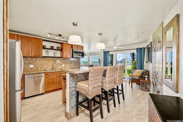 87-561 Farrington Hwy Unit 102, Waianae, HI 96792 - kitchen with stainless steel appliances, a sink, brown cabinets, backsplash, and open shelves