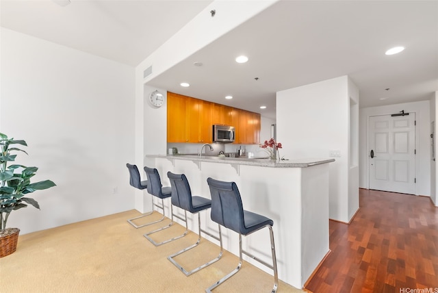 520 Lunalilo Home Rd Unit 7411, Honolulu, HI 96825 - kitchen with stainless steel microwave, recessed lighting, light countertops, a peninsula, and a kitchen breakfast bar