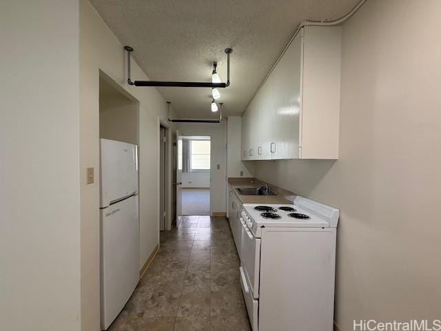 1550 Rycroft St Unit 528, Honolulu, HI 96814 - kitchen featuring white appliances, a sink, white cabinetry, a textured ceiling, and baseboards