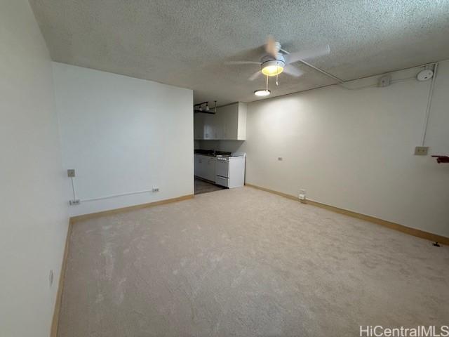 1550 Rycroft St Unit 528, Honolulu, HI 96814 - unfurnished living room featuring light colored carpet, ceiling fan, baseboards, and a textured ceiling
