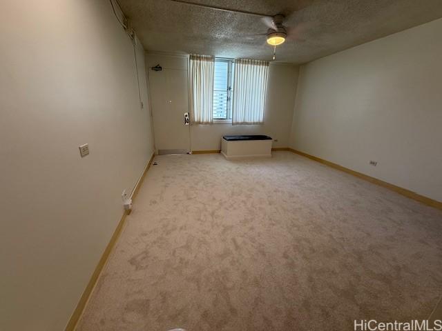 1550 Rycroft St Unit 528, Honolulu, HI 96814 - empty room with a textured ceiling, baseboards, light colored carpet, and a ceiling fan