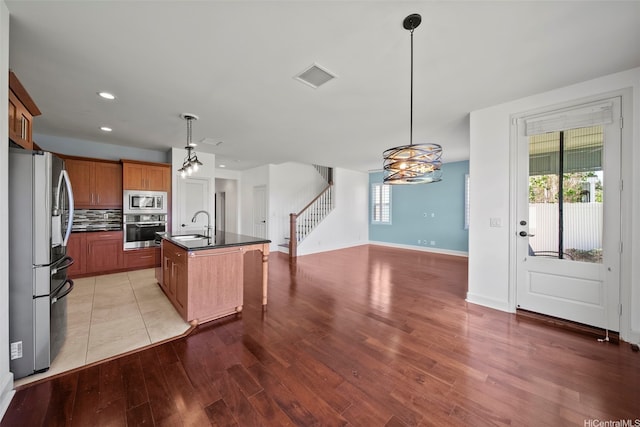 91-1304 Kaikohola St Unit D41, Ewa Beach, HI 96706 - kitchen featuring stainless steel appliances, dark countertops, a sink, open floor plan, and healthy amount of natural light