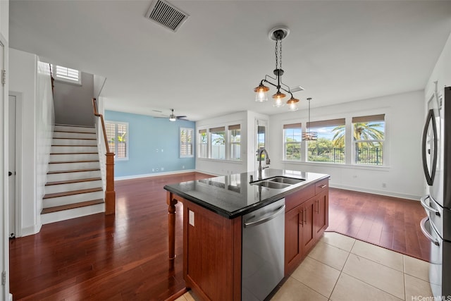 91-1304 Kaikohola St Unit D41, Ewa Beach, HI 96706 - kitchen with appliances with stainless steel finishes, a sink, light wood finished floors, baseboards, and healthy amount of natural light