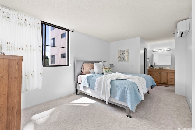 98-501 Koauka Loop Unit A704, Aiea, HI 96701 - bedroom featuring a wall unit AC, light carpet, a textured ceiling, and ensuite bathroom