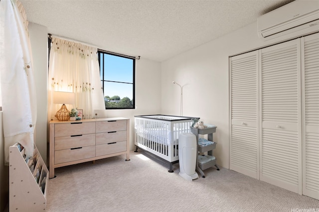 98-501 Koauka Loop Unit A704, Aiea, HI 96701 - bedroom with a wall mounted air conditioner, light carpet, a textured ceiling, and a closet