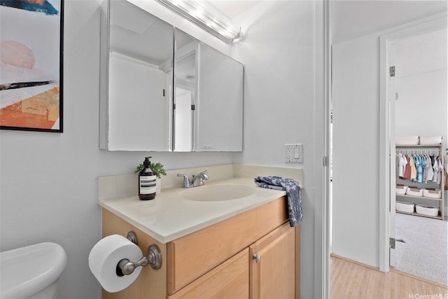98-501 Koauka Loop Unit A704, Aiea, HI 96701 - bathroom with vanity, wood finished floors, and toilet