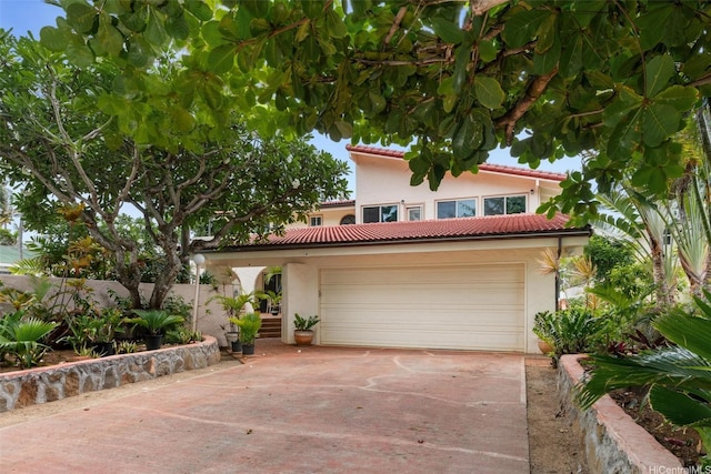 846 Mokulua Dr, Kailua, HI 96734 - mediterranean / spanish house with stucco siding, concrete driveway, a garage, and a tiled roof
