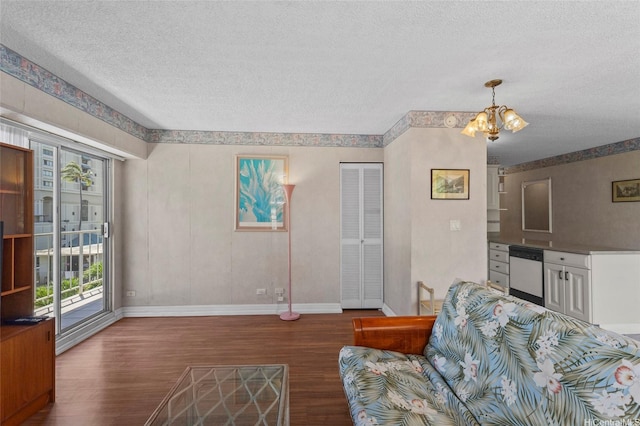 2115 Ala Wai Blvd Unit 501, Honolulu, HI 96815 - living room featuring wood finished floors, a textured ceiling, baseboards, and a chandelier