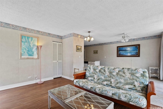 2115 Ala Wai Blvd Unit 501, Honolulu, HI 96815 - living area with wood finished floors, a textured ceiling, baseboards, and a ceiling fan