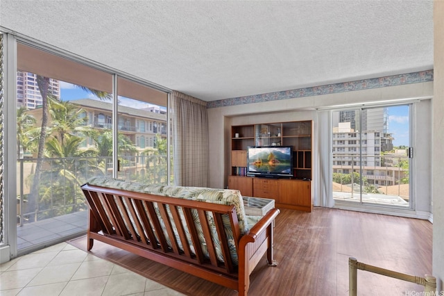 2115 Ala Wai Blvd Unit 501, Honolulu, HI 96815 - bedroom featuring access to exterior, a textured ceiling, and wood finished floors