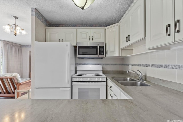 2115 Ala Wai Blvd Unit 501, Honolulu, HI 96815 - kitchen with white appliances, a sink, a chandelier, backsplash, and white cabinets