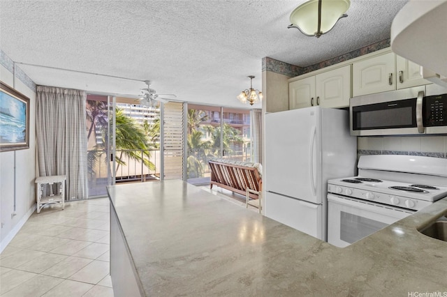2115 Ala Wai Blvd Unit 501, Honolulu, HI 96815 - kitchen featuring white appliances, light tile patterned floors, a chandelier, white cabinets, and ceiling fan