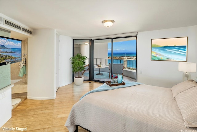 66 Queen St Unit 2904, Honolulu, HI 96813 - bedroom featuring wood finished floors, access to outside, a water view, and floor to ceiling windows