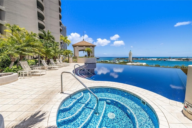 66 Queen St Unit 2904, Honolulu, HI 96813 - view of swimming pool with a community hot tub, a water view, and a patio