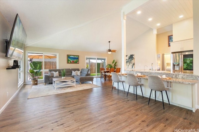 94-457 Akoa Pl, Mililani, HI 96789 - kitchen featuring stainless steel fridge with ice dispenser, ceiling fan, wood finished floors, recessed lighting, and high vaulted ceiling