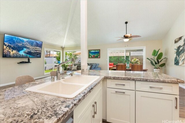 94-457 Akoa Pl, Mililani, HI 96789 - kitchen featuring a sink, a textured ceiling, white cabinetry, a ceiling fan, and baseboards