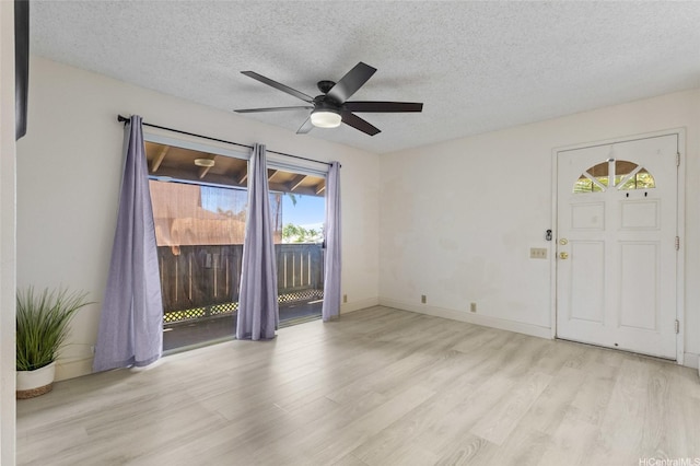 91-1040 Puamaeole St Unit 13R, Ewa Beach, HI 96706 - foyer with healthy amount of natural light, light wood-style flooring, a ceiling fan, and a textured ceiling