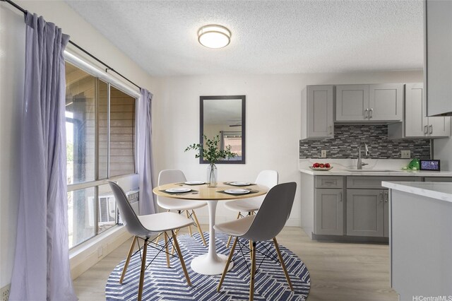 91-1040 Puamaeole St Unit 13R, Ewa Beach, HI 96706 - dining area with light wood finished floors and a textured ceiling