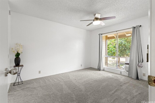 91-1040 Puamaeole St Unit 13R, Ewa Beach, HI 96706 - empty room with carpet floors, a ceiling fan, and a textured ceiling