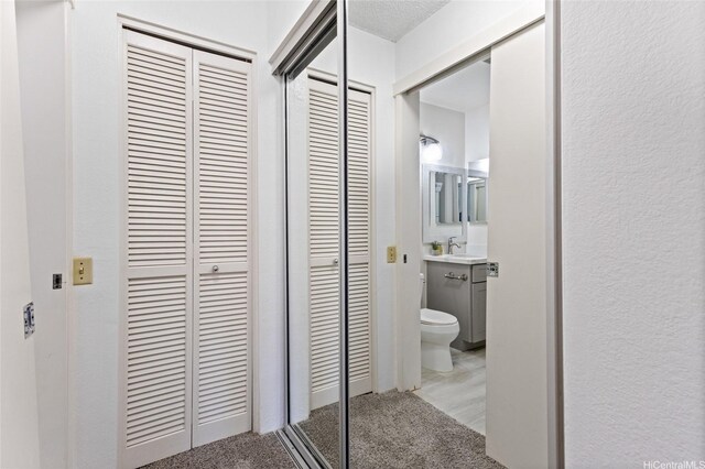 91-1040 Puamaeole St Unit 13R, Ewa Beach, HI 96706 - hall with carpet flooring and a sink