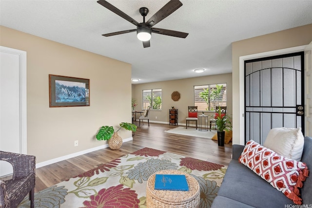 91-1338-A Karayan St, Ewa Beach, HI 96706 - living room featuring wood finished floors, ceiling fan, and baseboards