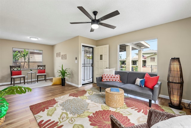 91-1338-A Karayan St, Ewa Beach, HI 96706 - living area featuring wood finished floors, baseboards, a ceiling fan, and a textured ceiling