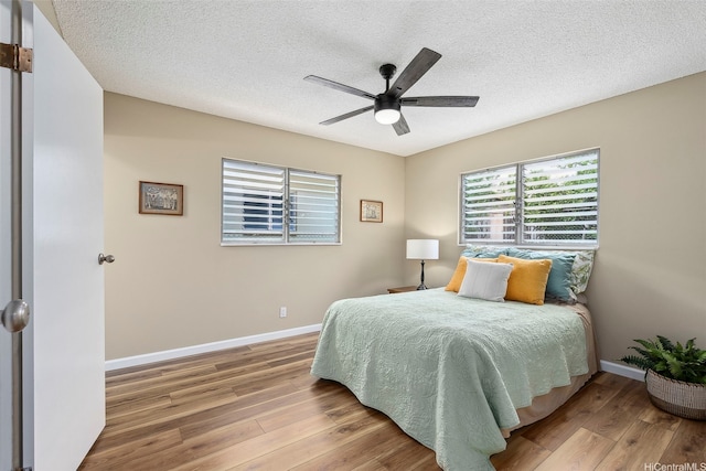 91-1338-A Karayan St, Ewa Beach, HI 96706 - bedroom with wood finished floors, baseboards, a textured ceiling, and a ceiling fan