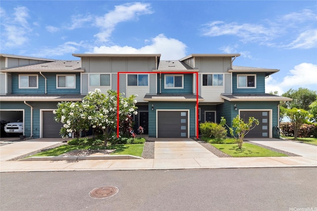 91-3524 Iwikuamoo St Unit 402, Ewa Beach, HI 96706 - townhome / multi-family property with an attached garage, board and batten siding, and driveway
