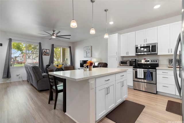 91-3524 Iwikuamoo St Unit 402, Ewa Beach, HI 96706 - kitchen with stainless steel appliances, open floor plan, light countertops, light wood-type flooring, and recessed lighting