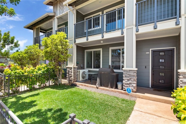 91-3524 Iwikuamoo St Unit 402, Ewa Beach, HI 96706 - view of exterior entry with a balcony and a cooling unit
