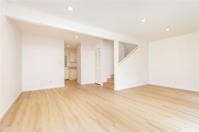 44-374 Olina St Unit 1, Kaneohe, HI 96744 - unfurnished living room with light wood-type flooring, recessed lighting, stairs, and baseboards