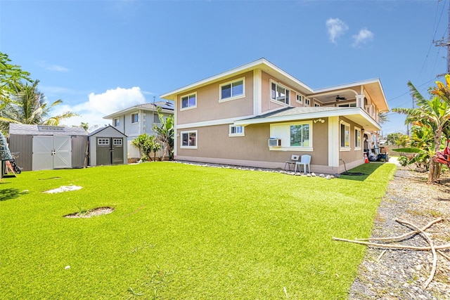 54-220 Kaipapau Loop, Hauula, HI 96717 - rear view of house featuring a yard, a ceiling fan, and stucco siding