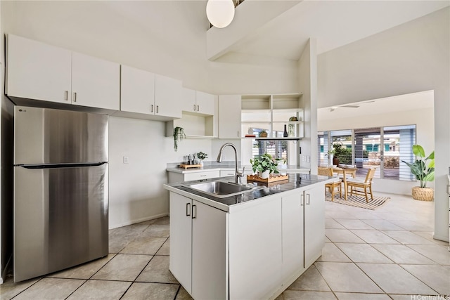 91-506 Pohakupuna Rd, Ewa Beach, HI 96706 - kitchen featuring freestanding refrigerator, a sink, a center island with sink, a high ceiling, and open shelves