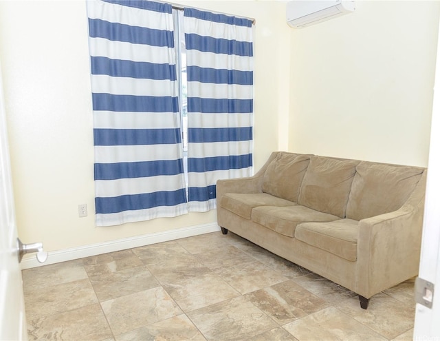 91-1019 Opuku St Unit B, Kapolei, HI 96707 - living area featuring a wall mounted air conditioner, baseboards, and stone finish flooring