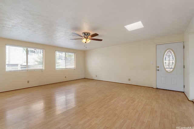 92-742 Nohopono St, Kapolei, HI 96707 - spare room featuring a ceiling fan, light wood-style floors, and a skylight