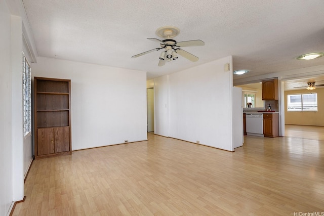 92-742 Nohopono St, Kapolei, HI 96707 - unfurnished living room featuring a ceiling fan, light wood-style floors, and a textured ceiling