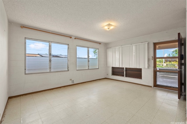 94-533 Ulieo St, Waipahu, HI 96797 - spare room with a textured ceiling, plenty of natural light, light flooring, and baseboards
