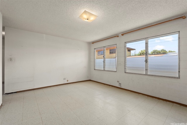 94-533 Ulieo St, Waipahu, HI 96797 - spare room featuring tile patterned floors, a textured ceiling, and baseboards