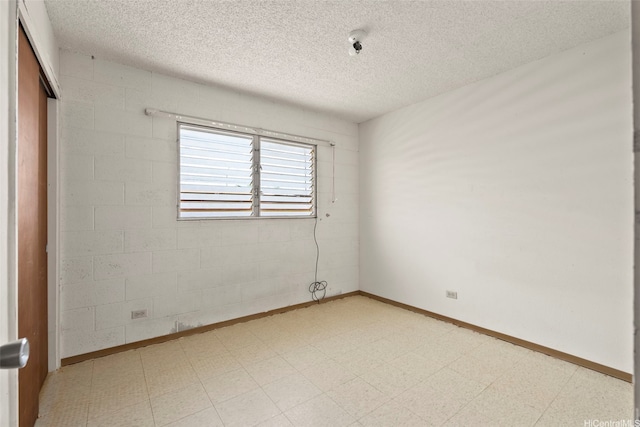 94-533 Ulieo St, Waipahu, HI 96797 - empty room featuring a textured ceiling, light floors, and baseboards