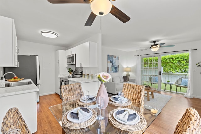 46-1032 Emepela Way Unit 13A, Kaneohe, HI 96744 - dining space featuring a ceiling fan, light wood-style floors, and baseboards