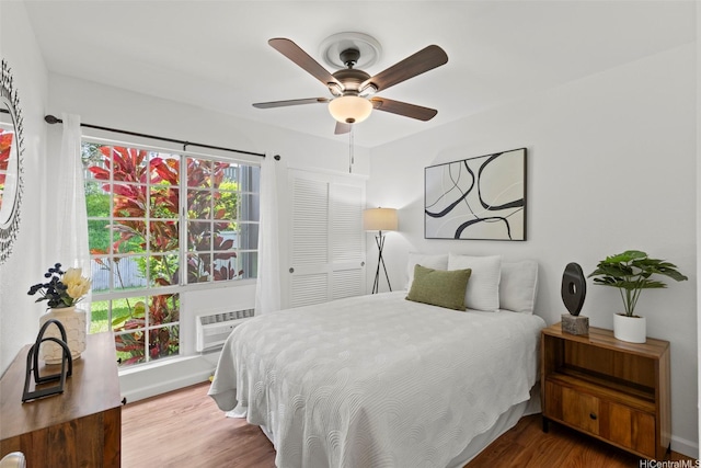 46-1032 Emepela Way Unit 13A, Kaneohe, HI 96744 - bedroom featuring wood finished floors, an AC wall unit, and a ceiling fan