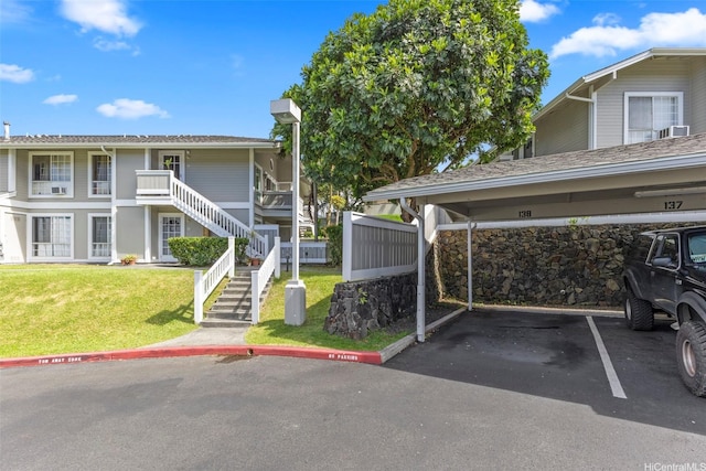 46-1032 Emepela Way Unit 13A, Kaneohe, HI 96744 - view of building exterior featuring stairs and covered parking