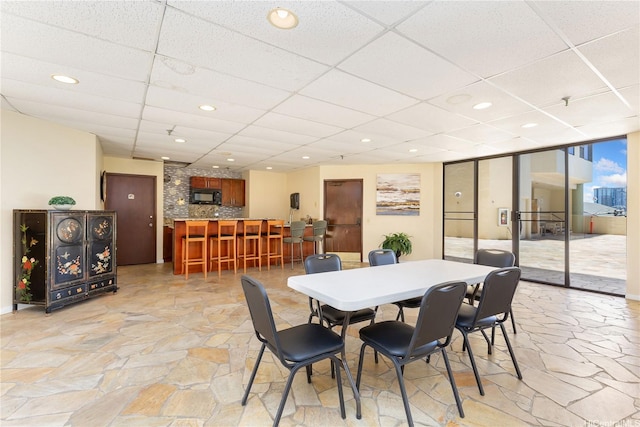1760 S Beretania St Unit 15B, Honolulu, HI 96826 - dining area featuring stone flooring, a drop ceiling, and recessed lighting