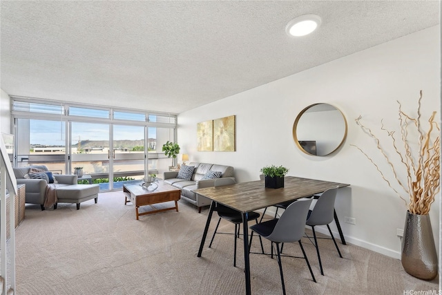 500 University Ave Unit 532, Honolulu, HI 96826 - dining space with light carpet, expansive windows, a textured ceiling, baseboards, and a water view