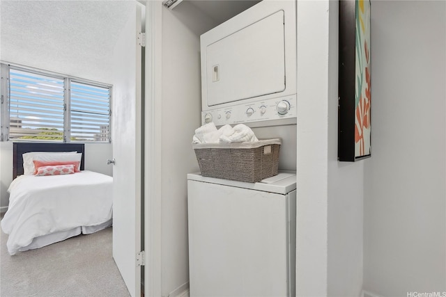 500 University Ave Unit 532, Honolulu, HI 96826 - washroom featuring stacked washer and clothes dryer and carpet flooring