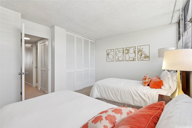 500 University Ave Unit 532, Honolulu, HI 96826 - bedroom with a textured ceiling, a closet, and carpet flooring
