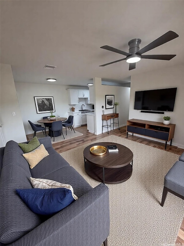 255 Mananai Pl Unit 52T, Honolulu, HI 96818 - living room featuring light wood-type flooring, ceiling fan, and baseboards