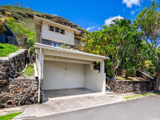 509 Lawelawe St, Honolulu, HI 96821 - view of front of property featuring concrete driveway, a carport, and a balcony